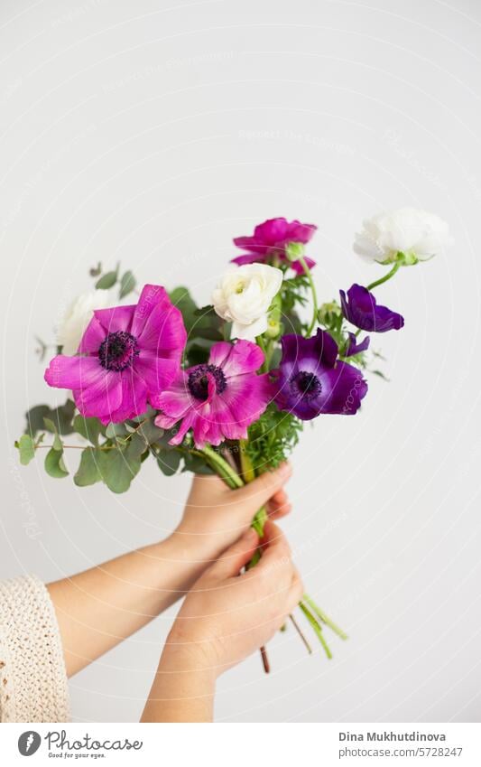 hands of  woman holding bouquet of flowers on white background. I can buy myself flowers. Happy Birthday or Anniversary. floral florist beautiful decoration