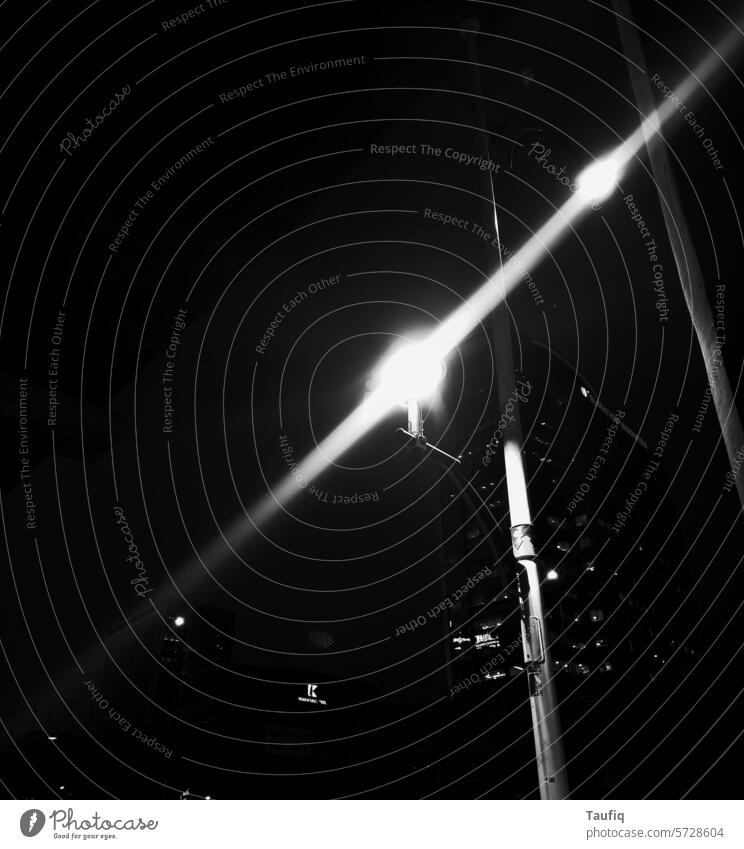 random beaming lights in the street of the city Night life night photography Black & white photo Street lighting street photography