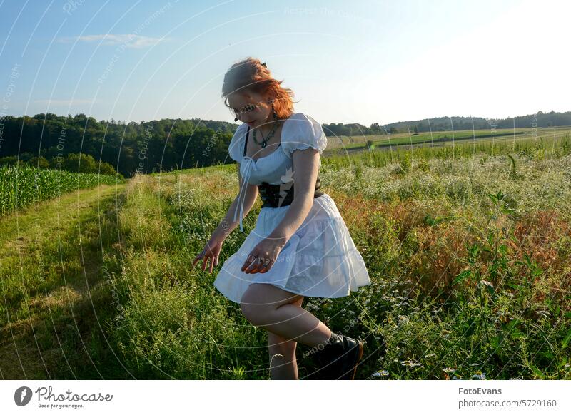 Young woman running in a high meadow portrait stroll nature sweet young trees summer Caucasian outside personable model white copy space active teenager joy