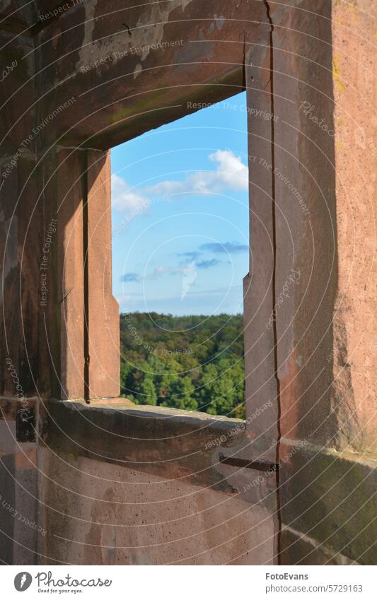 View through an old castle window on a  sky and green landscape white Castle copy space building blue nature day architecture background opening clouds