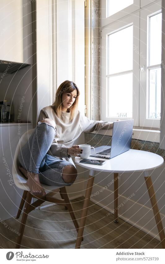 Serene morning with a young woman using laptop coffee table window minimalistic technology calm serene white chair work home interior natural light comfort