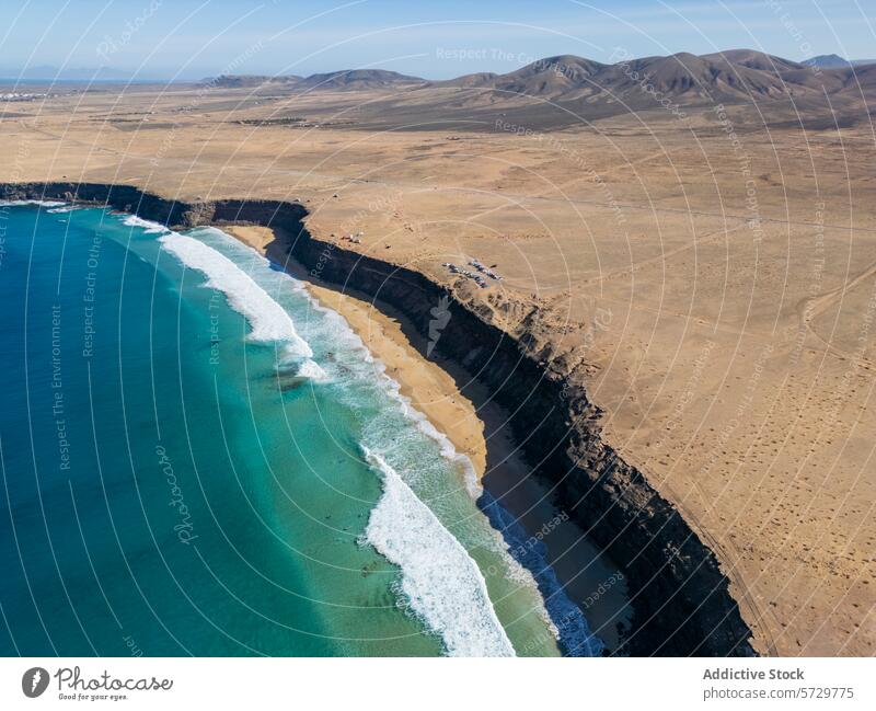 Aerial View of Fuerteventura Coastline and Rugged Terrain aerial drone view fuerteventura coastline rugged terrain ocean blue azure arid landscape beach waves