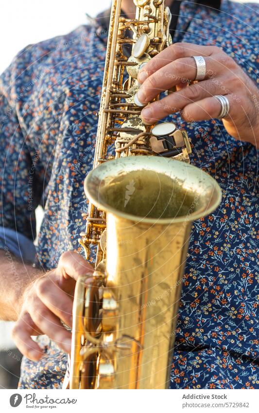 Close-up of a man playing saxophone, looking away saxophonist male brass instrument hands music musician performance jazz close-up cropped hobby entertainment
