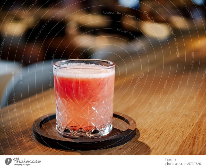 Glass of fresh grapefruit juice in restaurant interior glass bar counter club pub citrus ripe sweet beverage healthy tasty drink refreshment background table