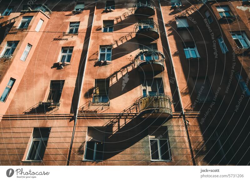 Balconies cast long shadows Facade Balcony Sunlight Architecture Worm's-eye view Contrast Authentic Style Apartment Building Oriel Silhouette