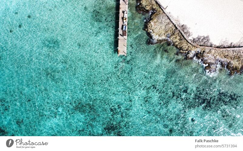 Wooden jetty on the Caribbean dream beach above aerial Aerial view background bay beautiful blue boat bridge coast destination drone green holiday holidays