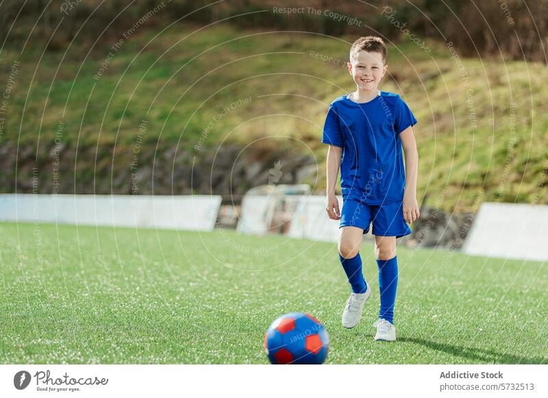 Young boy in soccer uniform ready to play field ball sport game young child youth happy smiling sportswear kick athletic fitness health exercise fun