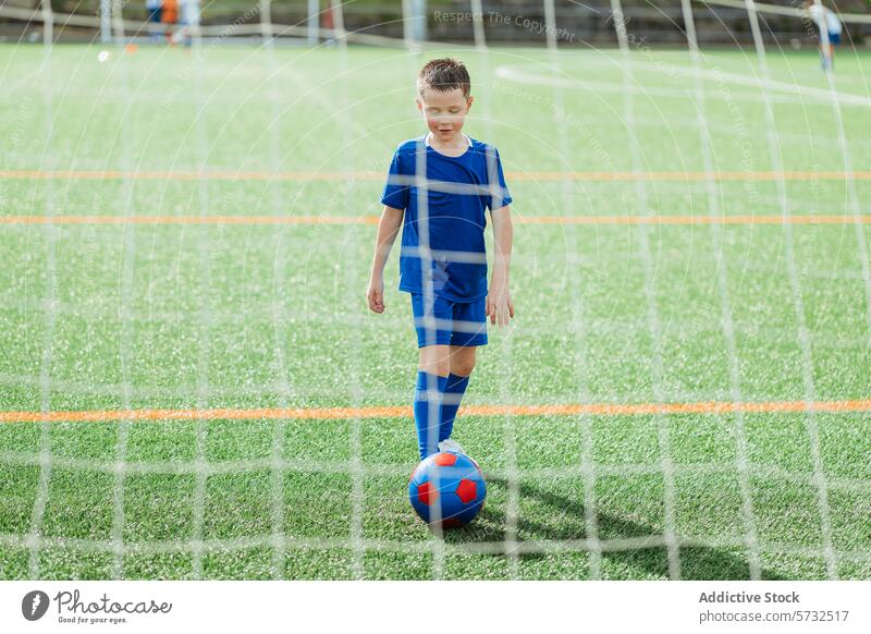 Young soccer player ready to kick the ball on field boy sport game uniform child youth goal athletic activity competition outdoor team sportswear fitness hobby
