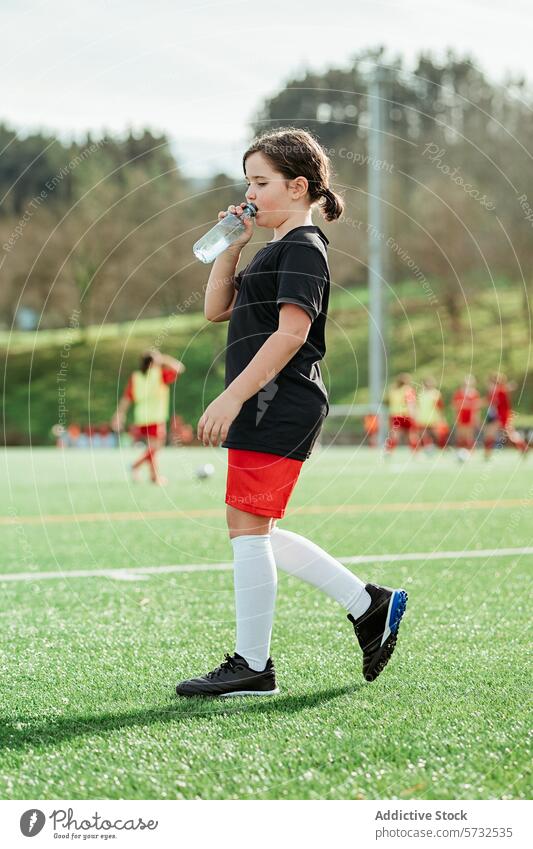 Young Soccer Player Hydrating During Practice girl soccer water break hydration field sport teammate background practice young athletic drink health leisure