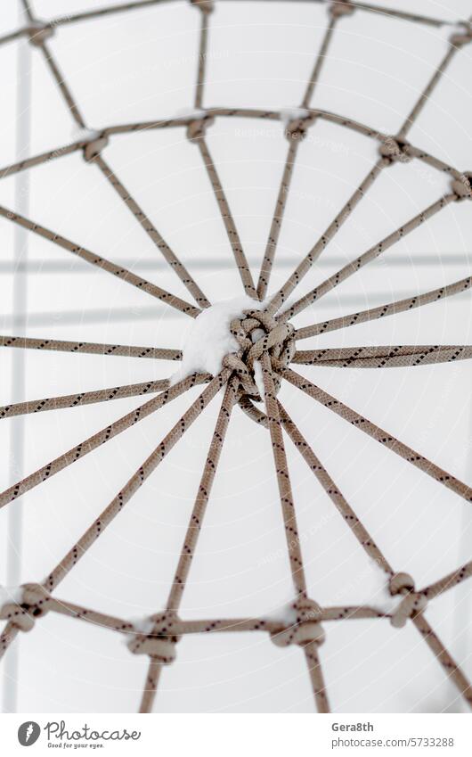 tied rope in the snow close up abstract abstract background affiliation apposition attachment backboard background of ropes cable close-up closeup cobweb