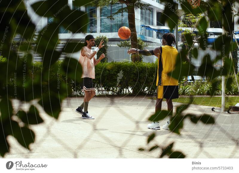 Best friends playing streetball on sunny afternoon, active lifestyle concept game leisure fun weekend together sportswear people basketball outdoor sportsman