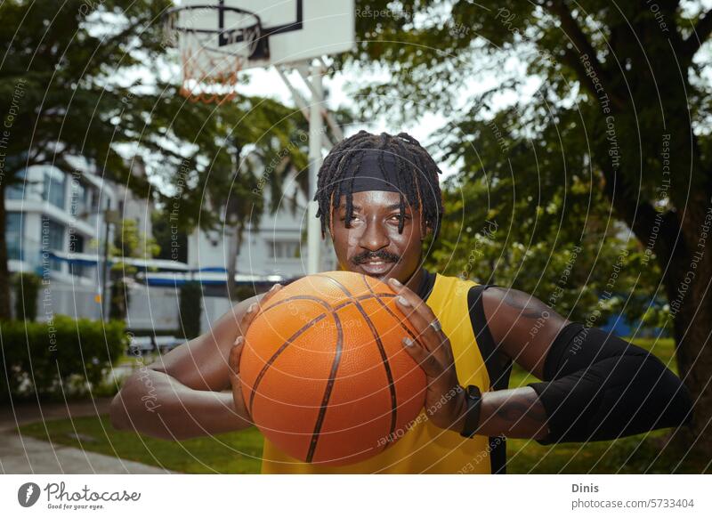Portrait of positive basketball player training on street court streetball throw portrait guy active sportsman athlete fun goal hands person game outdoor friend