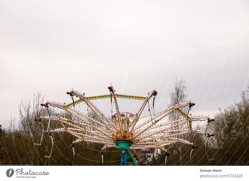 Carousel between trees, out of order in the open air Winter break Fairs & Carnivals Out of service Amusement Park Leisure and hobbies Circular movement