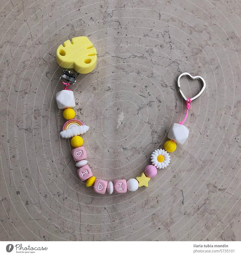 silicone pacifier holder in pastel colors personalized with name rainbow flowers yellow pink white baby infant newborn Child kid Newborn young girl sweet