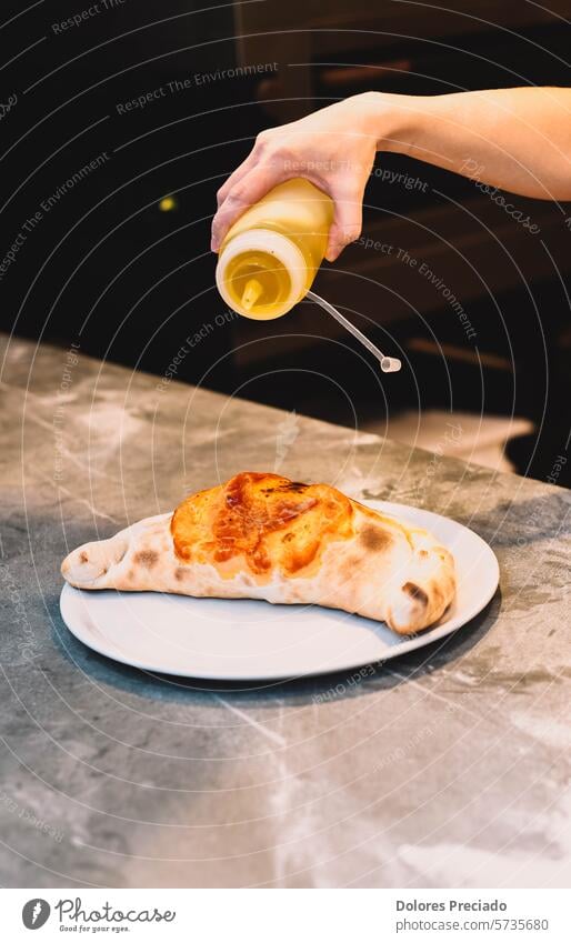 Traditional Italian calsone made with fresh dough in a wood-fired oven baked basil cheese classic cooked crust cuisine delicious delivery food dinner gourmet