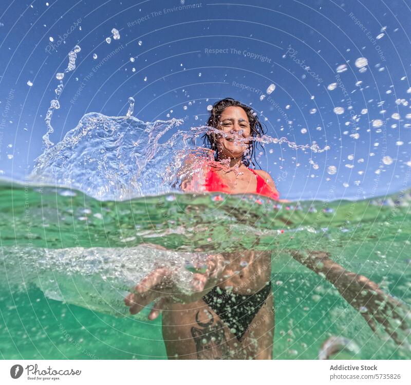 Woman Enjoying Refreshing Swim on a Summer Day woman swim water underwater summer joyful refresh sunlit bubble air submerge swimwear aquatic leisure activity
