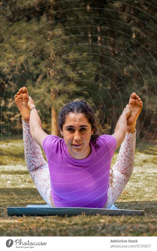 Intently practicing a yoga stretch, a woman connects with nature on her mat among the whispers of the forest focus clearing practice health wellness tranquility