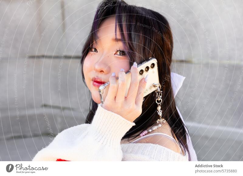 Stylish Gen-Z chinese girl posing with smartphone generation z model fashion trendy youth stylish urban accessory modern lifestyle female beauty portrait casual