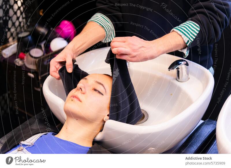 Client relaxing at salon during hair wash routine hair salon client towel basin sink care comfort hairdresser hair care beauty grooming hygiene hair treatment