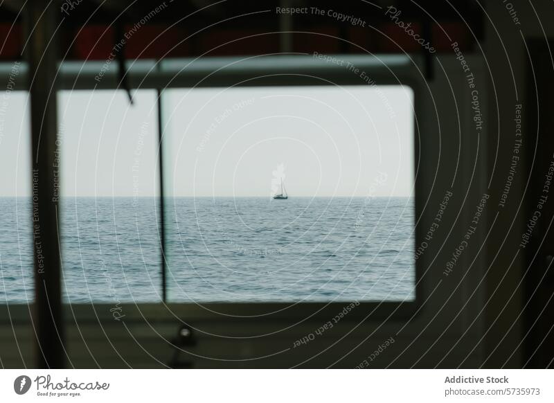 Sailing boat in the distance through window view frame sea ocean sailing tranquility serenity horizon maritime vessel nautical travel journey exploration calm