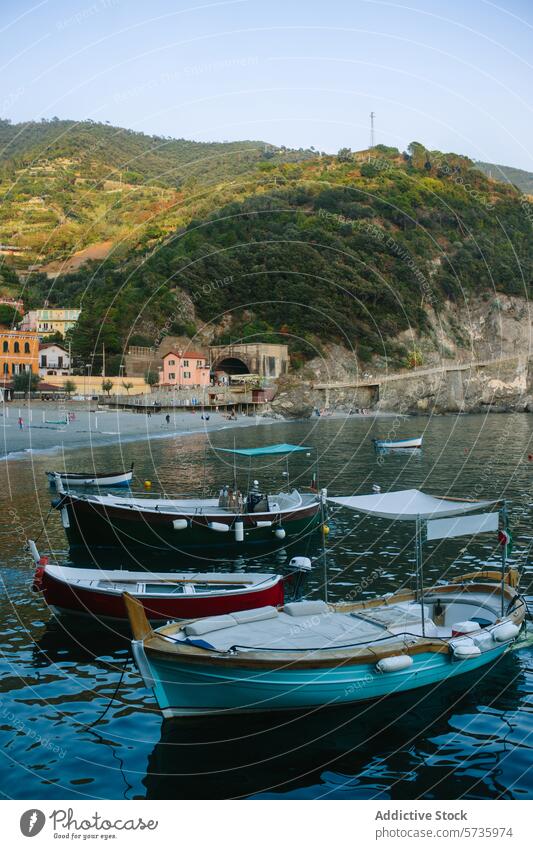 Peaceful harbor with boats and hills at dusk serene water calm building quaint lush backdrop float peaceful approach village mooring dock coastline shore