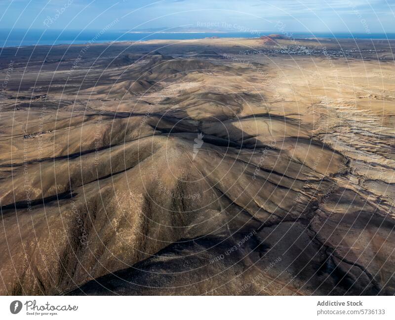 Volcanic landscape and coastal view of Fuerteventura fuerteventura aerial view volcanic barren hill surfing desert texture arid terrain island aerial shot