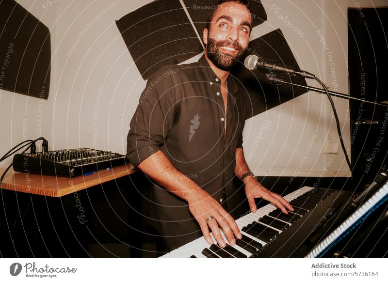 Smiling male musician playing keyboard and singing into microphone man electric keyboard looking away smile cheerful home studio performer entertainment artist