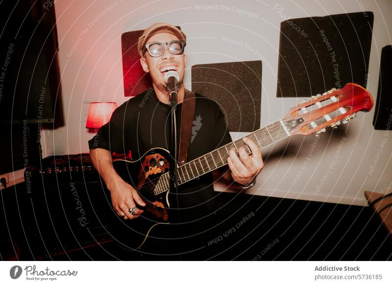 Joyful male guitarist performing in a music studio man musician acoustic guitar singing performance band joy cheerful entertainment song artist male performer