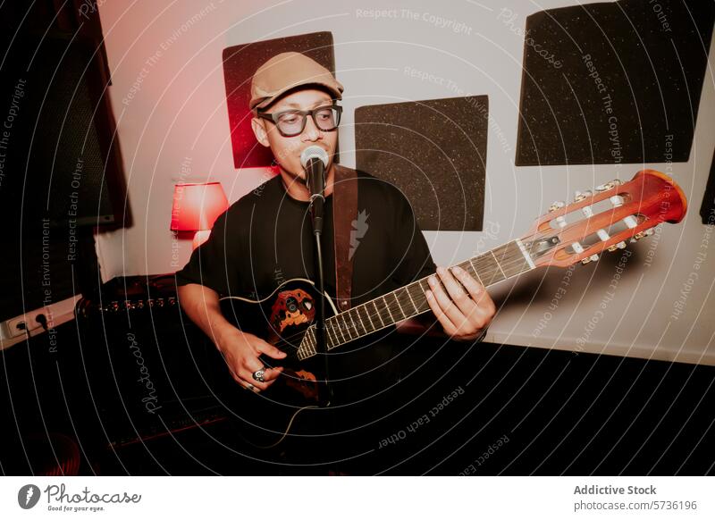Male Musician Performing with Guitar and Microphone musician male man guitar acoustic performance band singing microphone hat play instrument singer artist