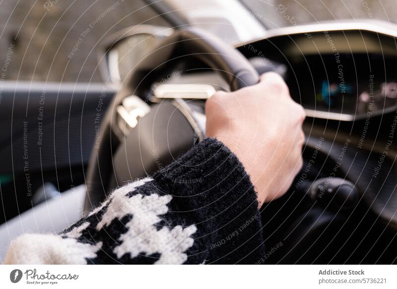 Close-up of hand steering a car with winter glove driving steering wheel cold vehicle close-up car interior safety transportation driver grip control dashboard