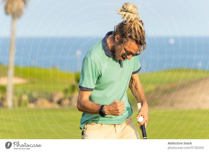 Golfer with Dreadlocks Celebrating on the Course golfer dreadlocks celebration golf course male sunny sea golf game happiness reaction sport outdoor leisure