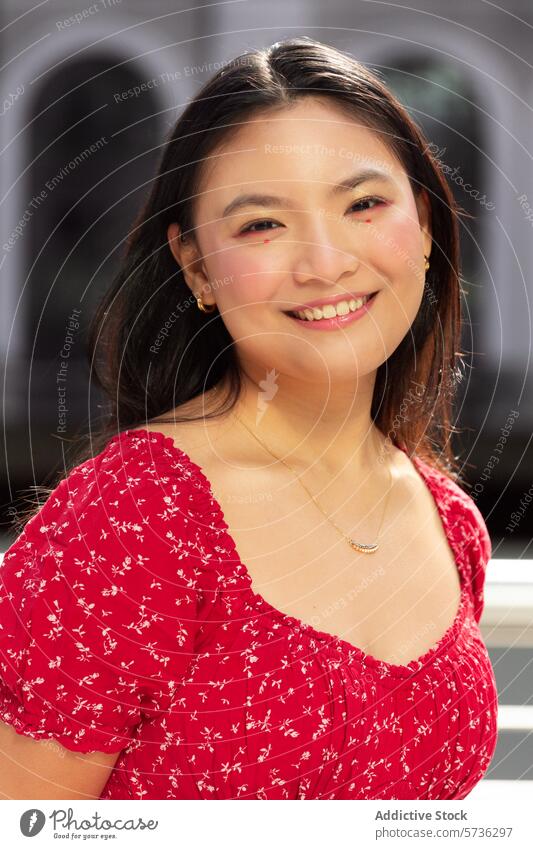 Smiling woman in red enjoying a sunny outdoor setting asian smile happy dress floral joyful portrait close-up fashion style casual elegant cheerful positive