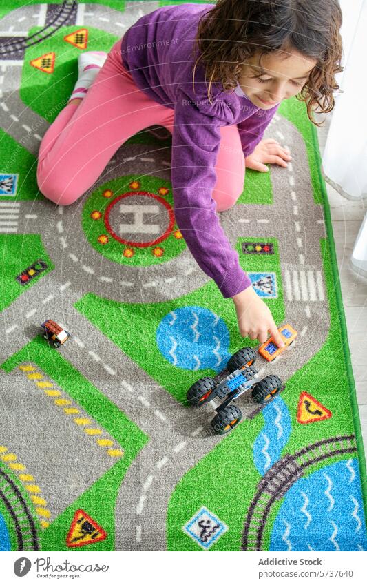 Girl playing with toy cars on a colorful play mat girl child imagination game indoor childhood action playtime leisure fun activity carpet pattern texture room