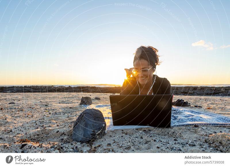 Digital nomad working on laptop at sunset on beach digital nomad remote work woman smiling freelance travel sea technology work-life balance outdoor lifestyle