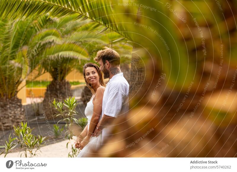 Summer romance amidst tropical greenery couple summer outfits smiling holding hands palm trees vegetation love lush garden happiness intimacy relationship