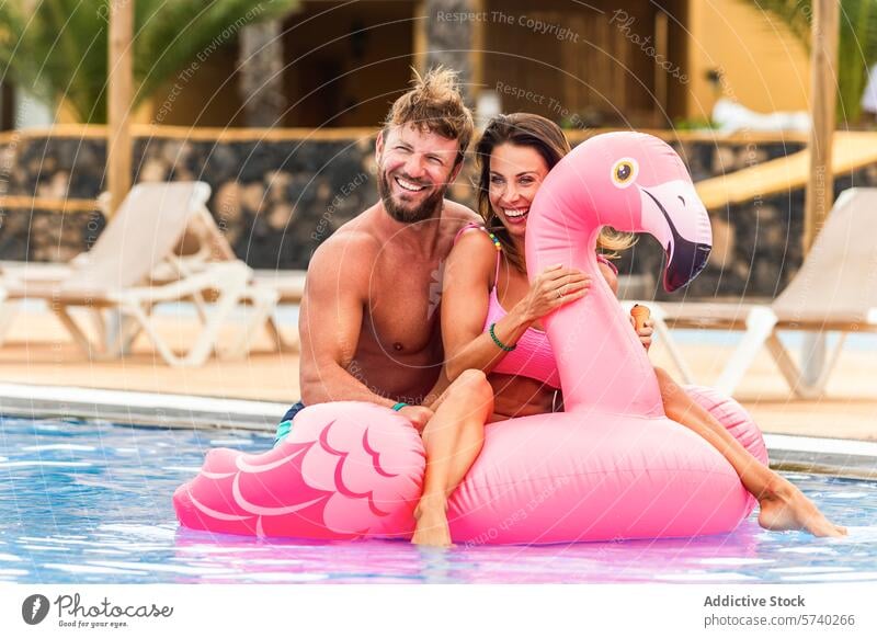 Couple enjoying a summer day in a pool with a flamingo float couple swimming vacation resort leisure fun happy water relaxation lifestyle inflatable swimwear