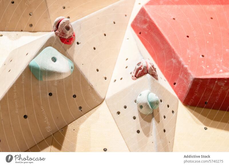 Close-up of indoor climbing wall with colorful holds handhold foothold texture rock climbing facility detail close-up sport hobby exercise fitness challenge