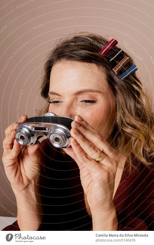 Woman looking through binoculars. Photo in studio with isolated background. adult analyst asian attractive concept content discovery entrepreneur face female