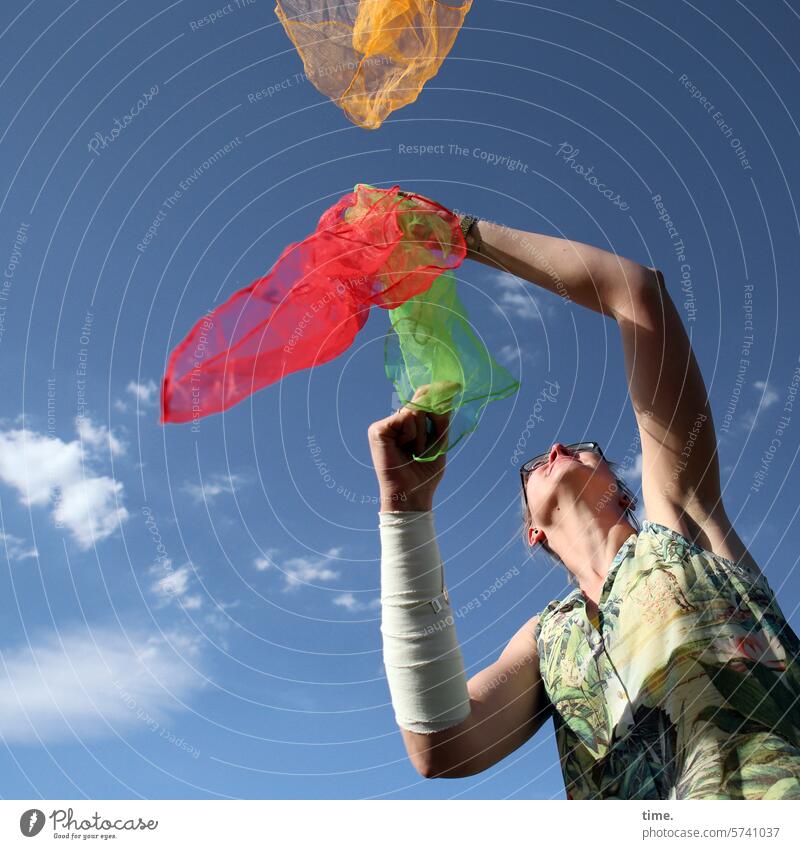 Woman with flying scarves cloths Rag juggling Acrobatics Sports Movement Art Bandage Sky Clouds Arm Shirt Dynamics Worm's-eye view Joy Flying Hover Summer