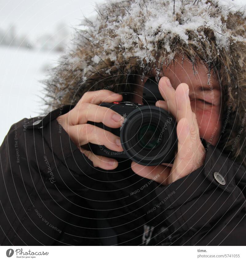 photographing the photographer Take a photo Woman Winter camera Snow Cold Landscape closed eye Hooded (clothing) Jacket Coat Objective Fingers Hand stop Freeze