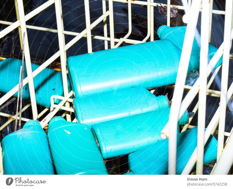 Empty plastic containers in different sizes on an old shelf plastic waste Turquoise Identical mass production packaging waste serial Structures and shapes bins