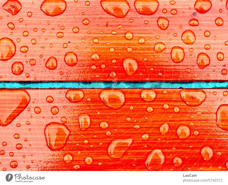 Water-repellent - raindrops on orange wood Drops of water hydrophobic roll off dripping off Wet Damp Rain Shifty weather Orange colored Brilliant rainy day