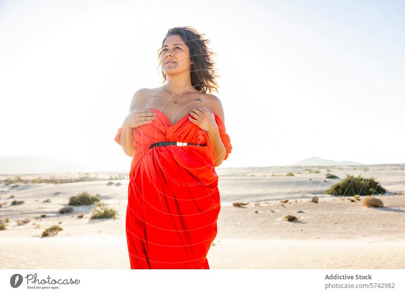 Woman in Red Embracing the Desert Landscape woman red dress desert dunes elegance style fashion warm summer nature outdoor beauty serene tranquil peaceful
