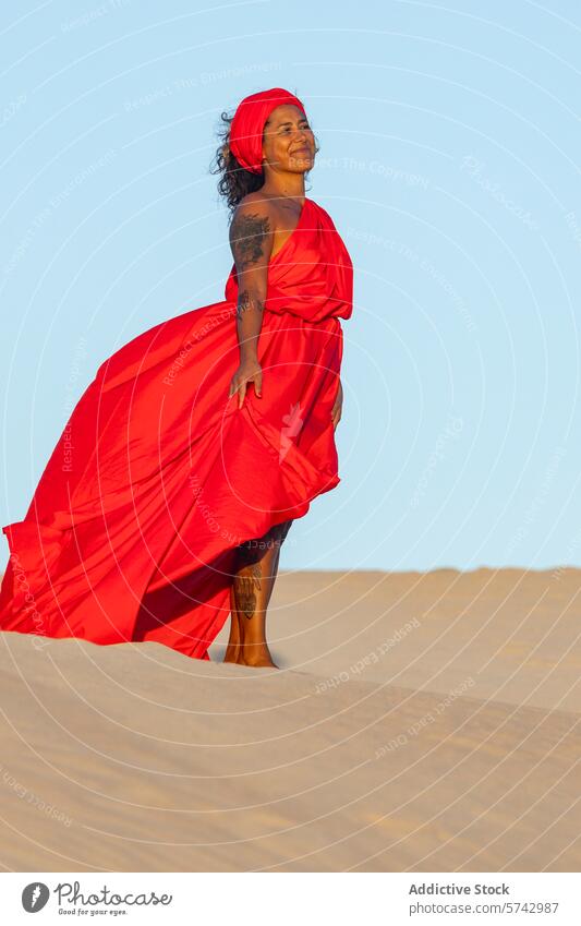 Elegant woman in red dress on sand dunes desert headscarf elegant serene content flowing fabric outdoor natural beauty grace peaceful tranquil tattoo fashion