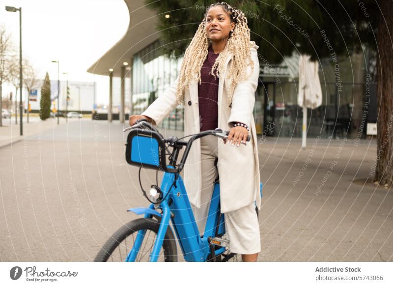 Urban commuting: Woman with bike in city setting woman female african american urban bicycle style fashion chic outdoor modern lifestyle street casual