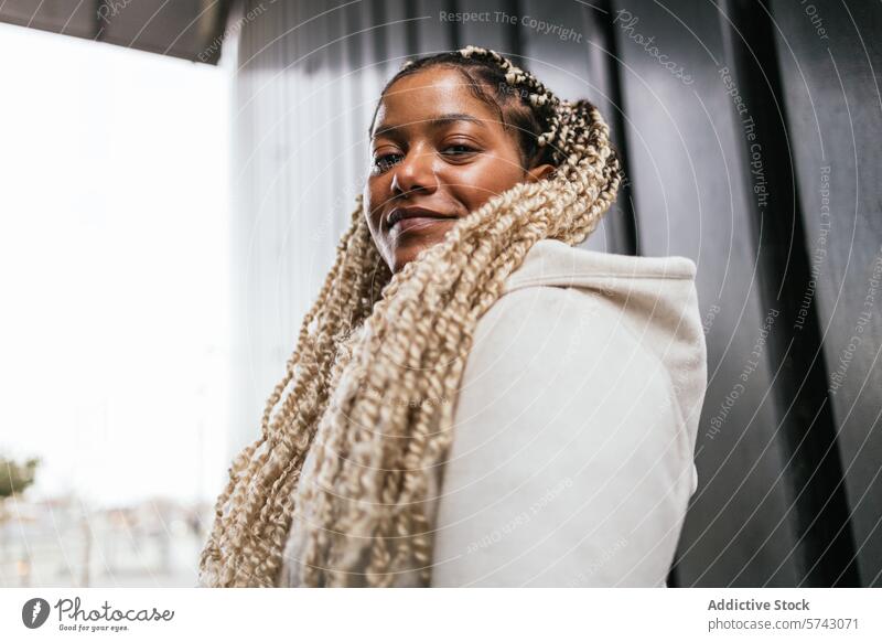 Confident African American woman in urban setting female african american city smile confident stylish braids scarf fashion street casual portrait young adult