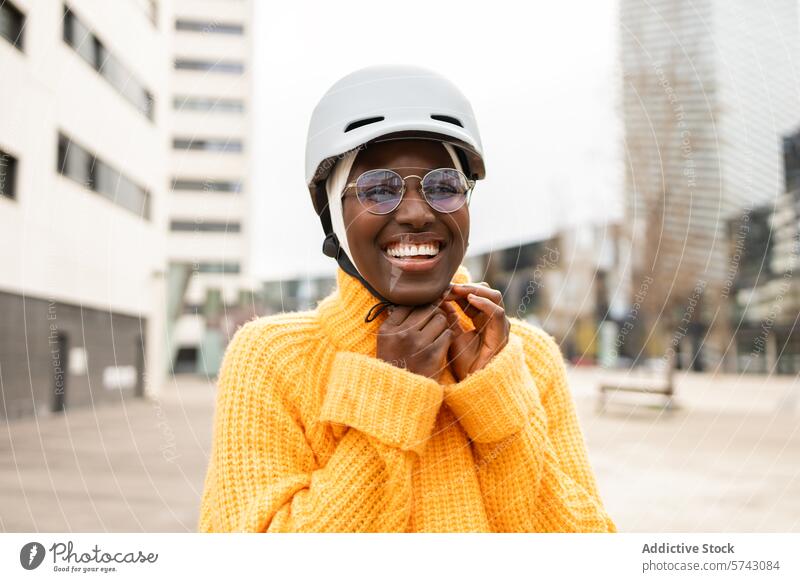 Cheerful woman with helmet in urban setting female black african american safety glasses smile city cheerful joy safety gear fashion casual lifestyle young