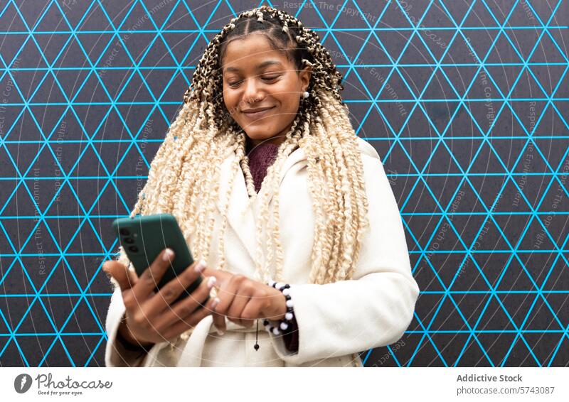 Smiling Black woman using smartphone in urban setting female black african american city content smiling geometric backdrop mobile device gadget