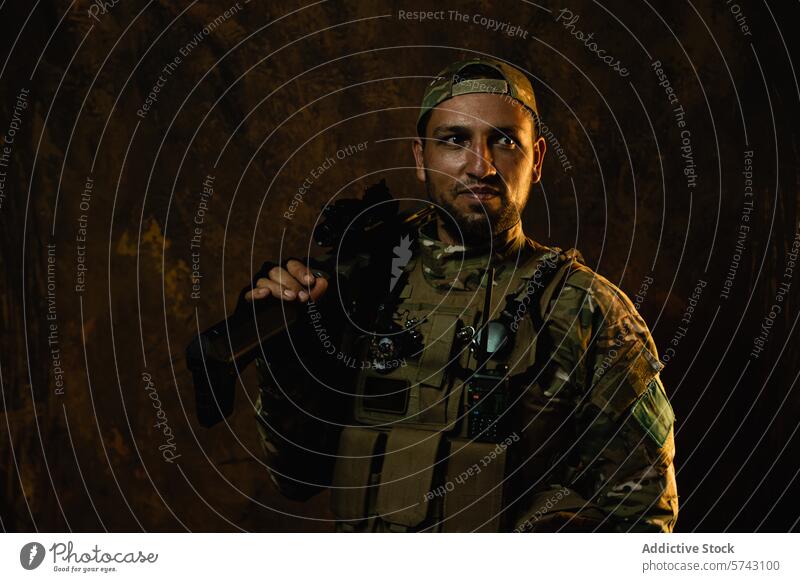 A Latin American soldier with a confident gaze stands with his rifle, outfitted in tactical combat gear military uniform camouflage vest stance service armed