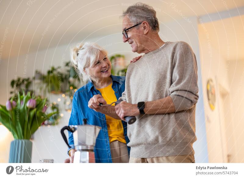 Senior couple preparing coffee at home people caucasian grey hair casual day portrait indoors real people white people adult mature retired old lifestyle senior